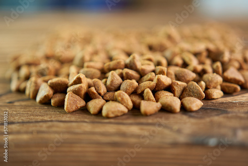 Dry cat food on a wooden background. Food for pets. © Vin.rusanov