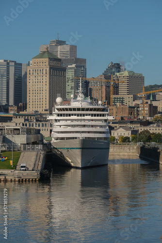 German luxury cruiseship cruise ship liner Amera in port of Montreal, Quebec in Canada with city downtown skyline on sunny summer autumn day during New England Indian summer cruising on St Lawrence © Tamme