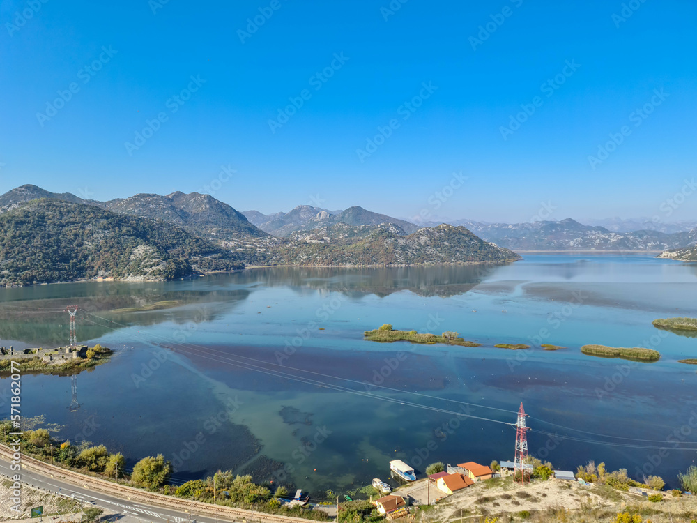 Scenic view on beautiful lake of Skadar National Park on sunny autumn day seen from Vranjina, Bar, Montenegro, Balkans, Europe. Travel destination, Dinaric Alps near Albania. Magical water reflection