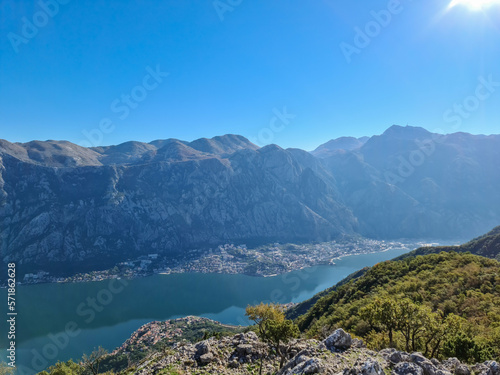 Panoramic view from mountain summit of Sveti Ilija on Kotor bay in sunny summer  Adriatic Mediterranean Sea  Montenegro  Balkans  Europe. Fjord winding along steep cliffs. Hiking trail in Dinaric Alps