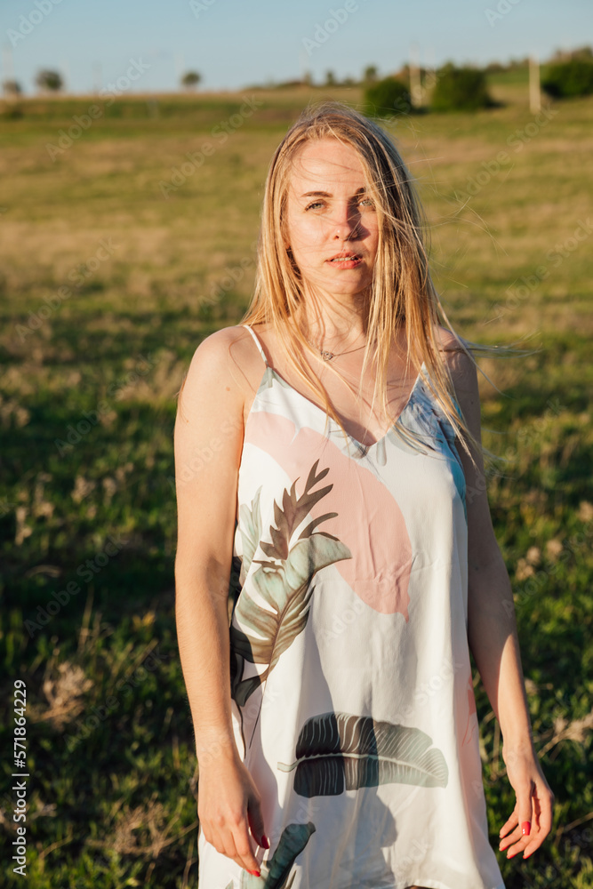 a woman in a beautiful summer dress in nature in a clearing a woman in a beautiful summer dress in nature in a clearing