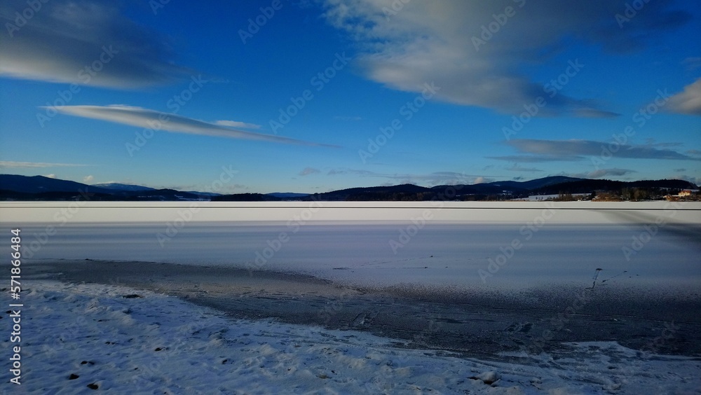 Frozen surface of Lipno reservoir sunny winter day with blue skies