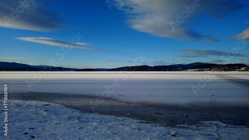 Frozen surface of Lipno reservoir sunny winter day with blue skies