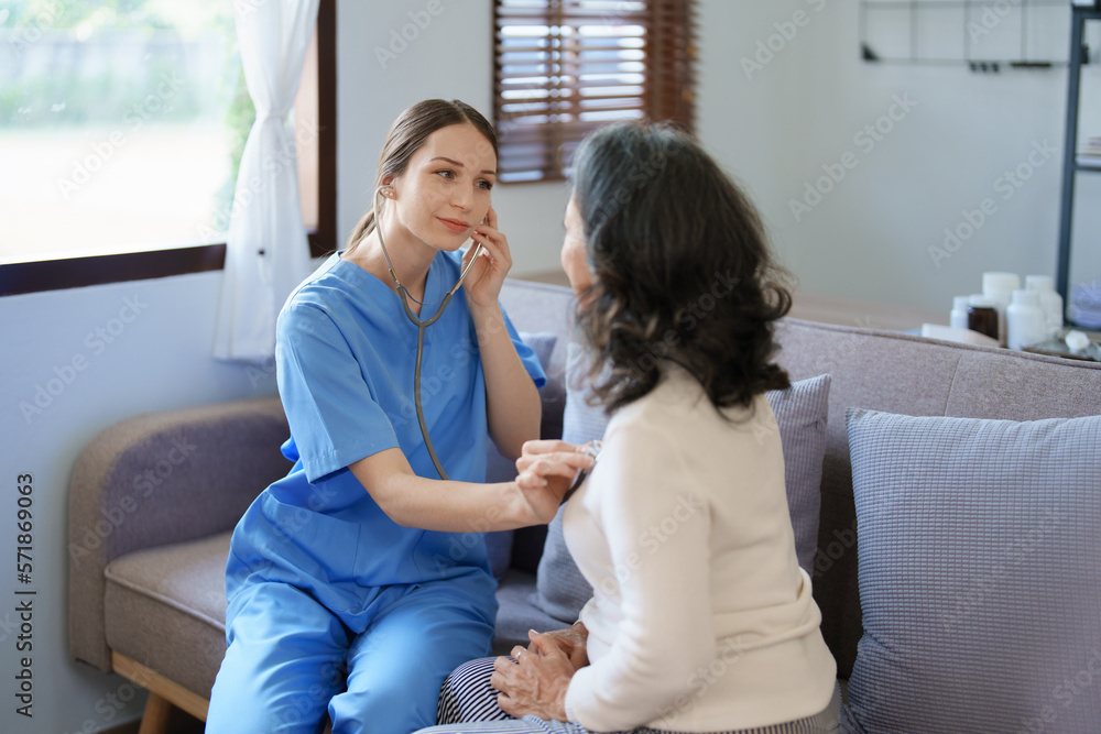 Portrait of a female doctor using a stethoscope to check the pulse of an elderly patient.