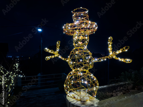 Snowman with hat Christmas illumination decoration at night