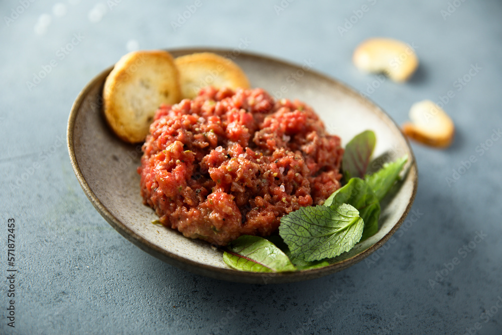 Homemade steak tartare with baguette bread Homemade steak tartare with baguette bread