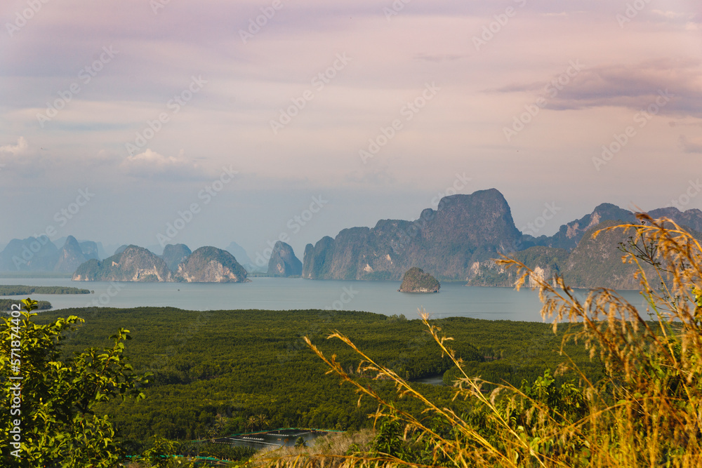 Top view on Phang nga bay Phuket. Samet Nangshe view point. High angle view of breathtaking limestone islands surrounding with emerald green water in blue sky summer.