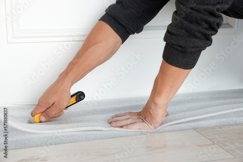 Worker installing new laminate flooring in room, closeup