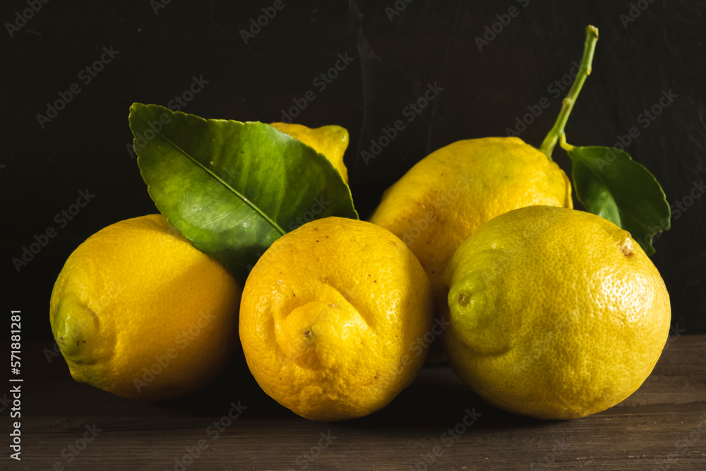 Lemon fruit.Lemon fruit with leaf isolated. Whole lemons on a wooden table