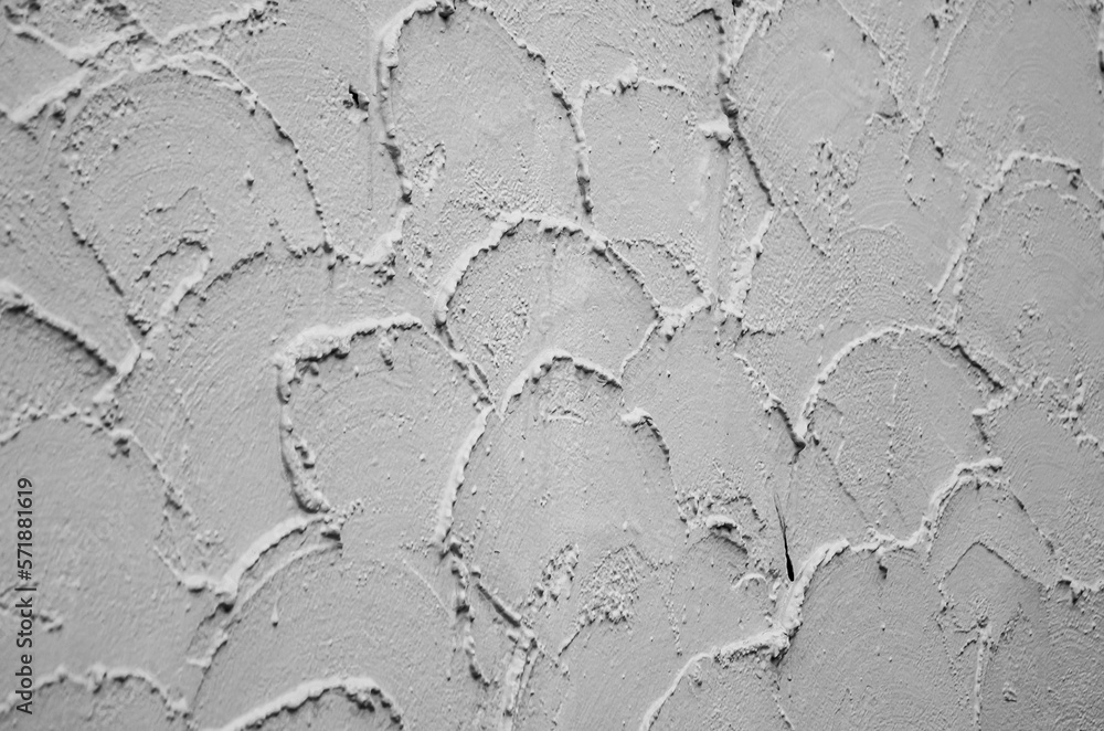 Texture of decorative plaster. background of plaster roughly applied to wall in form of semicircles
