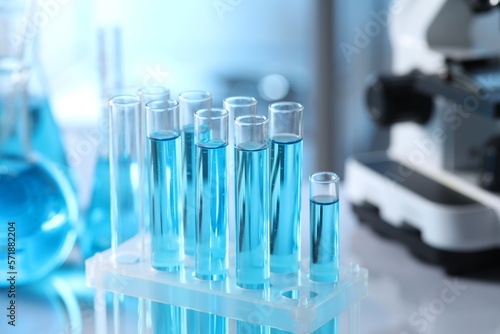 Test tubes with light blue liquid in laboratory, closeup