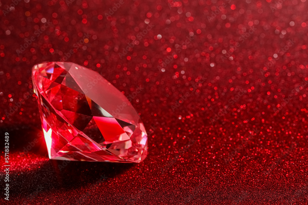 Beautiful shiny diamond on red glitter background, closeup. Space for text Beautiful shiny diamond on red glitter background, closeup. Space for text