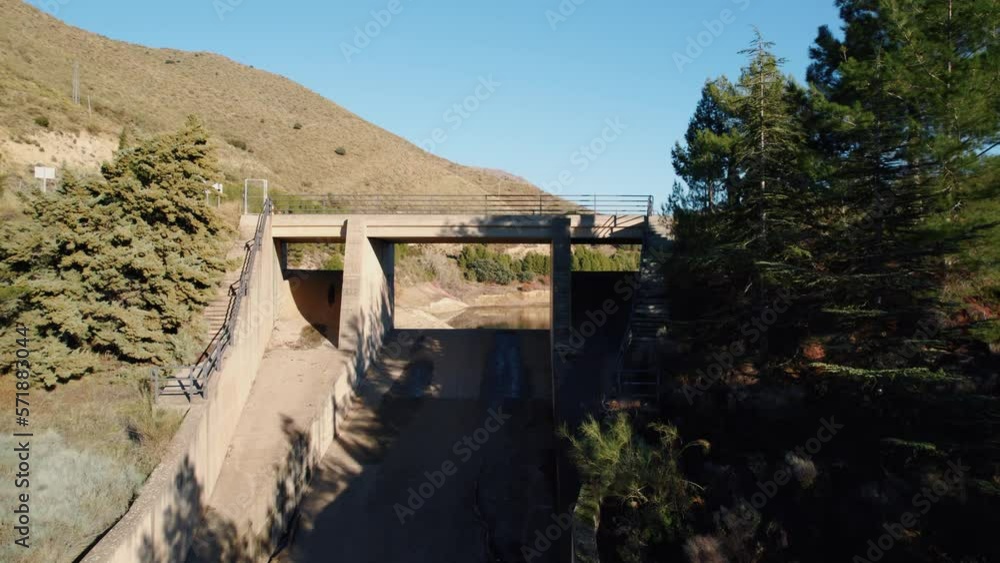 drone flight over one of the overflow channels of the Güéjar canales reservoir in spain through the opening and with a view of a water tower drone flight over one of the overflow channels of the Güéjar canales reservoir in spain through the opening and with a view of a water tower