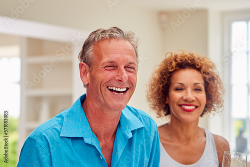 Group Of Multi-Cultural Senior Friends On Summer Vacation Meeting For Drinks In Holiday Apartment