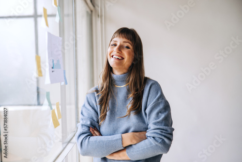 Young businesswoman smiling at the camera in a creative office