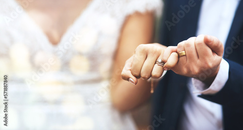 Hands, groom and bride with wedding rings in pinky promise for commitment, swear or vow on mockup. Hand of married couple in love, partnership or trust for marriage bond, loyalty or agreement photo