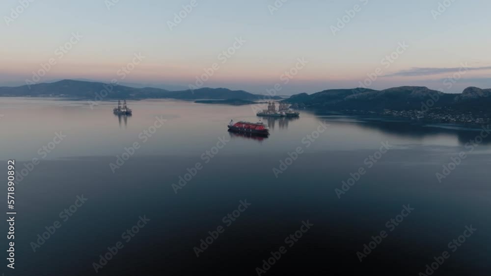Aerial: Panoramic shot of anchored LNG tanker in calm water Aerial: Panoramic shot of anchored LNG tanker in calm water
