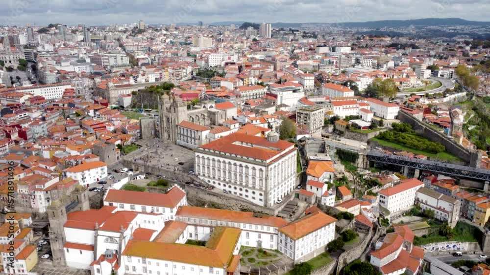 Aerial drone perspective of Porto city. View of old historic center. In the middle is Cathedral of Porto. Drone truck left. Beautiful landscape with painted in different colours. Rooftop of Porto city