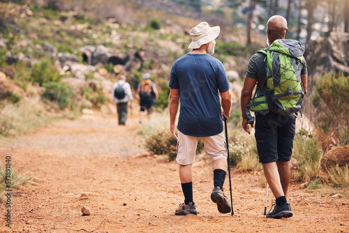 Hiking, fitness and people walking on mountain for adventure, freedom and wellness in outdoor forest. Travel, retirement health and senior hikers for exercise, trekking and cardio workout in nature
