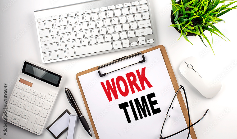 Business concept.Text WORK TIME on paper clipboard with,pencil,glasses, keyboard and calculator on white background. Business concept.Text WORK TIME on paper clipboard with,pencil,glasses, keyboard and calculator on white background.