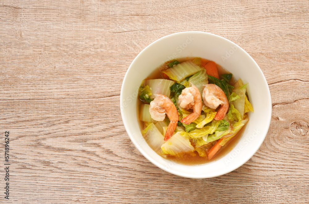 fried slice Chinese green cabbage and carrot with shrimp in soy sauce on bowl fried slice Chinese green cabbage and carrot with shrimp in soy sauce on bowl