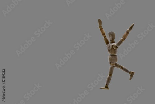 Photograph of a dark coloured wooden mannequin with neutral gray coloured background. Photo to be able to crop. Concepts. Selective focus. Space for copy