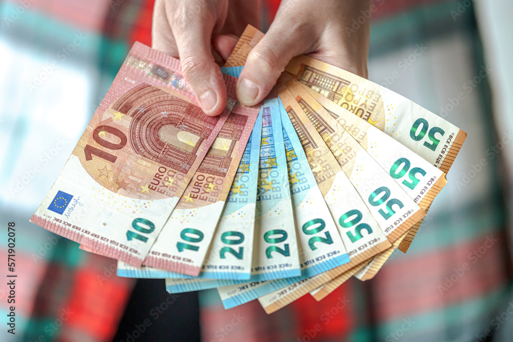 Woman showing euro banknotes of different value