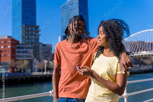 Young african american women in the city, lifestyle couple concept, walking talking by the river