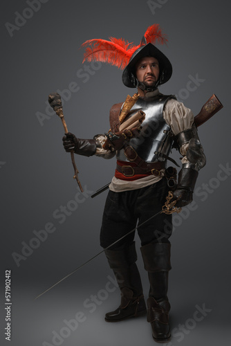 Принти на полотні Portrait of medieval conquistador dressed in plate armour holding torch and sword