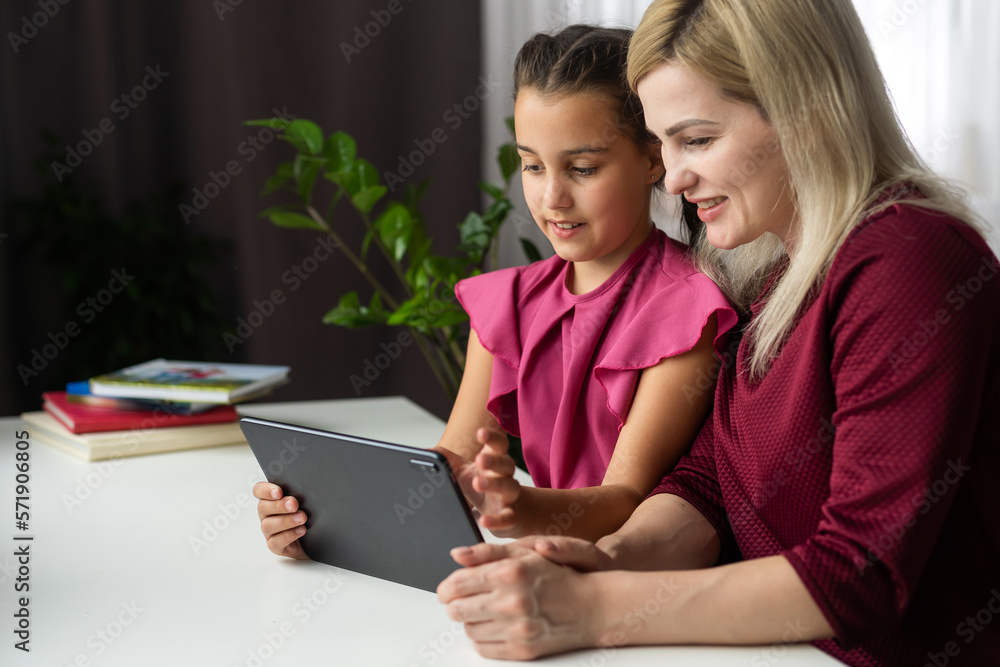 Mom with her tween daughter using tablet ipad together Mom with her tween daughter using tablet ipad together