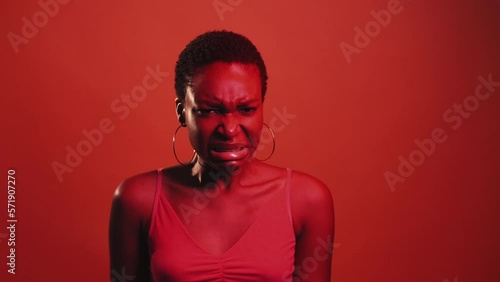 Disgust expression. Refusal no. Awful gross. Red neon color light displeased skeptic woman yuck face grimace isolated on dark bright gif loop boomerang animation.