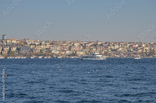 ferryboats on Bosporus strait and Anatolian side of Istanbul city view from Dolmabahce Palace pier