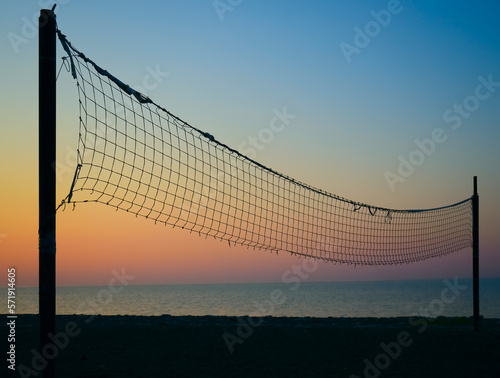 beach volleyball net in Batumi, Georgia. sunset light. Black Sea. sandy beach and sunrise. Silhouette of beach against sky during sunset.