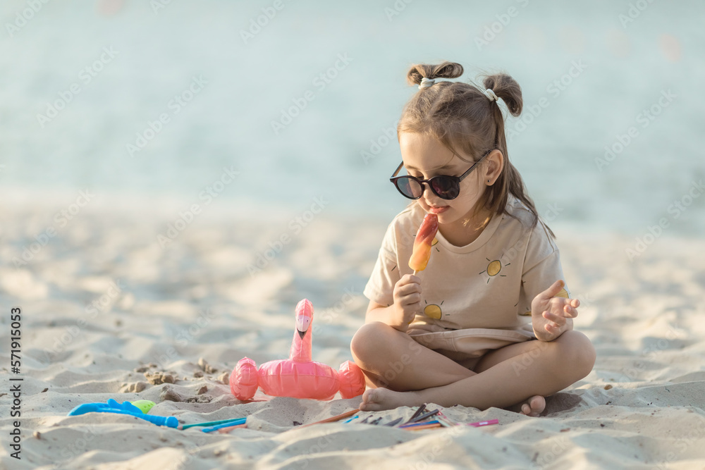 Little cute girl eating ice cream on the beach on vacation. Summer ...