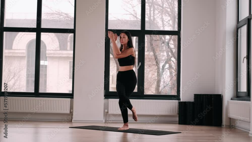 Young Woman doing balance exercise and Stretching sports Yoga, Black Sportswear Leggings and Top, bright room At home in the Morning. Fit Girl Practising Different Asana Poses on the Mat. Concept Young Woman doing balance exercise and Stretching sports Yoga, Black Sportswear Leggings and Top, bright room At home in the Morning. Fit Girl Practising Different Asana Poses on the Mat. Concept