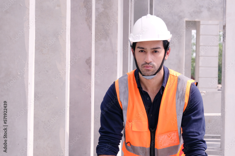 Young engineer in safety helmet standing at construction site building construction concept. Young engineer in safety helmet standing at construction site building construction concept.