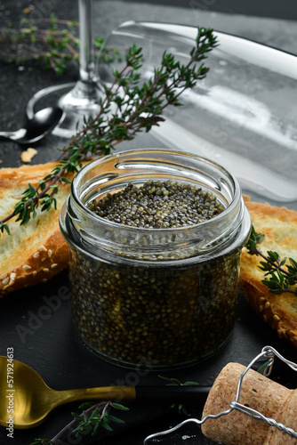 Beluga black caviar. High-quality caviar. On a black background. Macro photo. Free space for text.