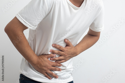 man having abdominal pain on white background