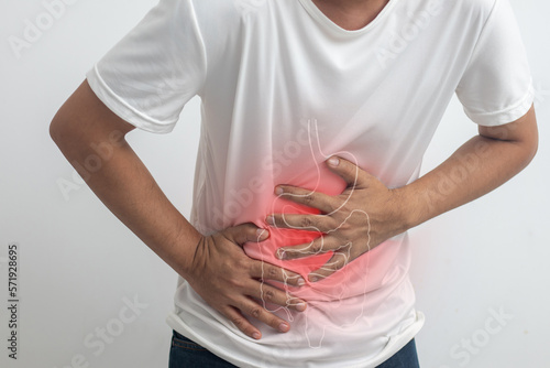 man having abdominal pain on white background