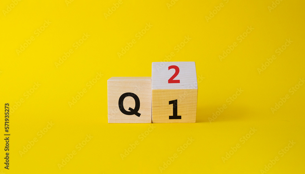 From 1st Quarter to 2nd symbol. Turned wooden cubes with words 1st Quarter and 2nd Quarter. Beautiful yellow background. Business and Quarter concept. Copy space From 1st Quarter to 2nd symbol. Turned wooden cubes with words 1st Quarter and 2nd Quarter. Beautiful yellow background. Business and Quarter concept. Copy space