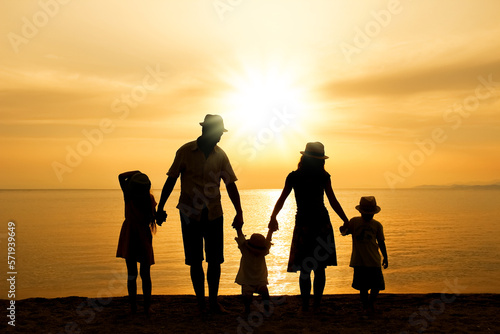 A happy family in nature by the sea on a trip silhouette © Kostia