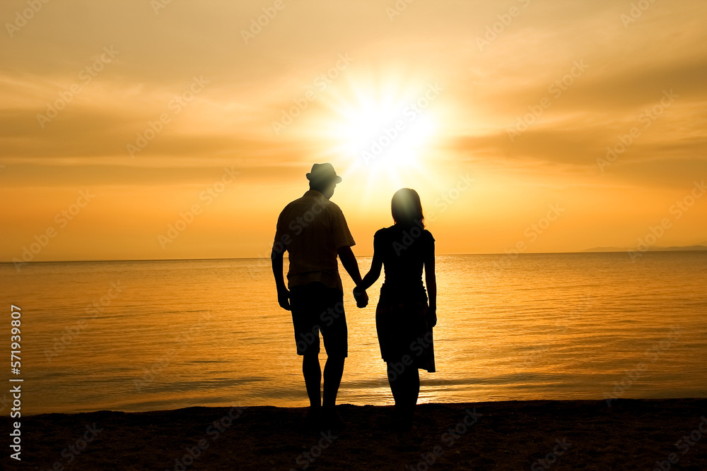 A happy couple by the sea on nature in travel silhouette