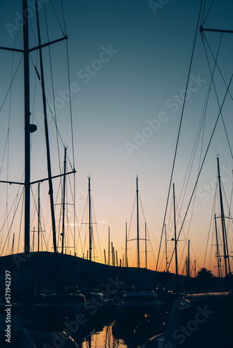 Close-up of yacht masts against the sunset sky. Marine theme