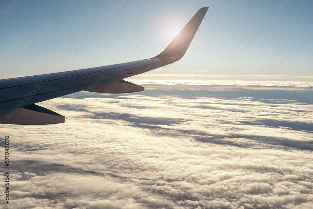 Obraz premium View from airplane window to sky with clouds. Flight over clouds and sunlight. Smooth delicate landscape flight 
