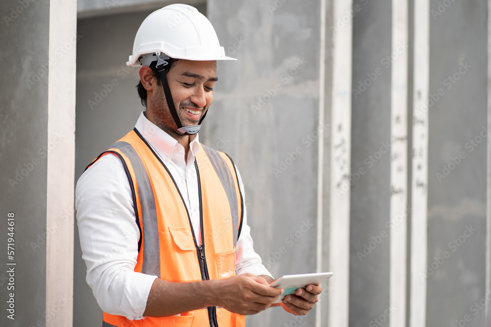 Happy Asia engineer man working with tablet at precast factory Happy Asia engineer man working with tablet at precast factory