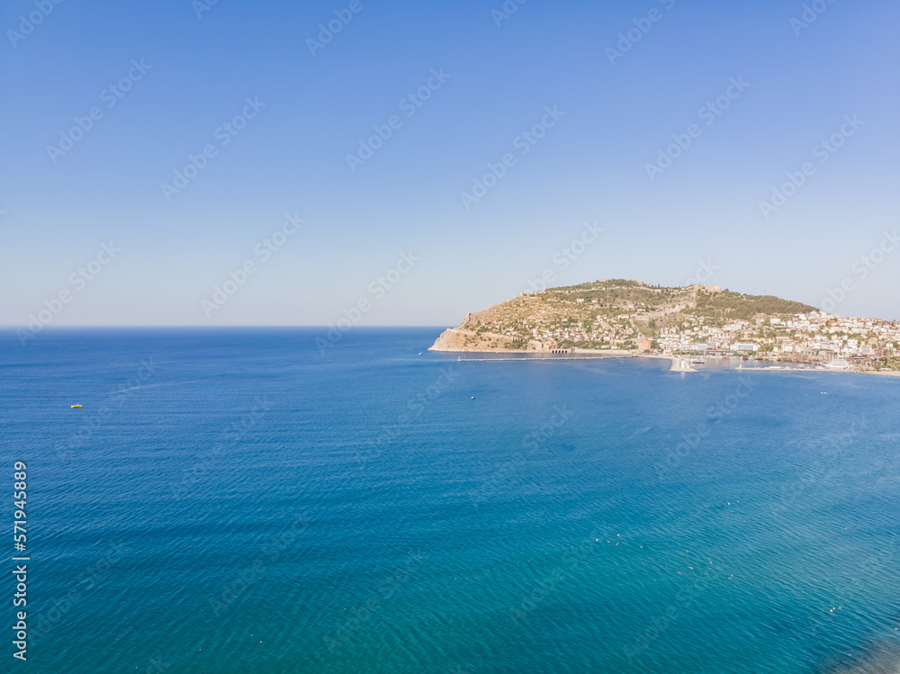 Coastline and promontory protruding into the sea, Alanya tourist city aerial view of the sea, sunny summer day
