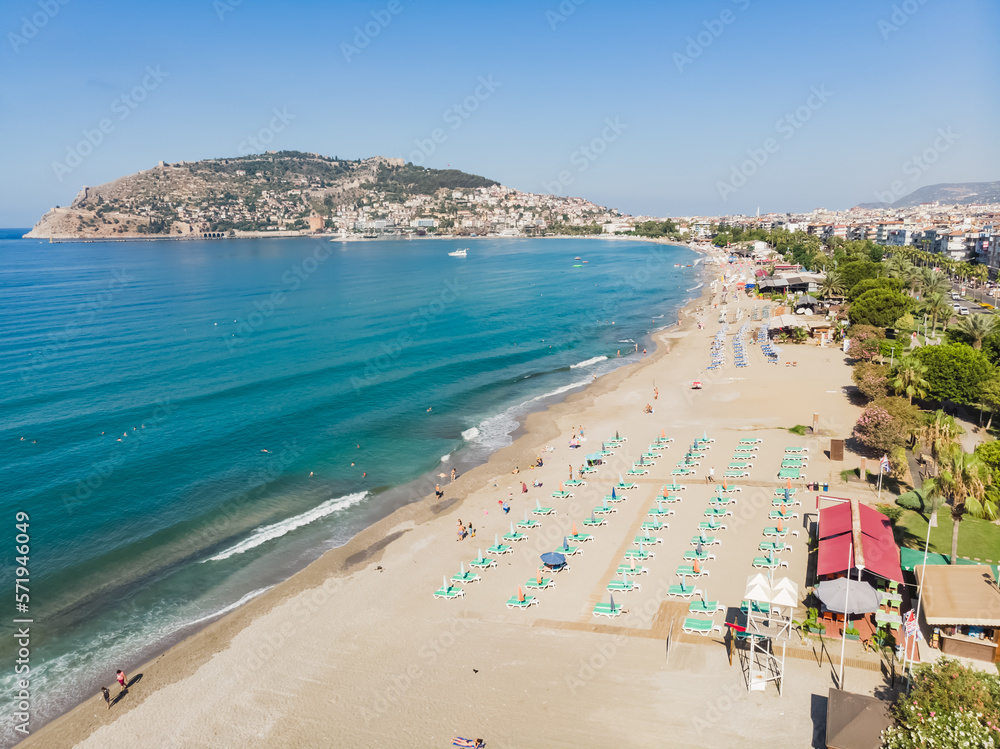 Coastline with beach, top view of the tourist city of Alanya in Turkey and the blue sea, on a sunny summer day