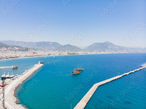 Top view of the tourist city of Alanya located between the mountains and the sea in Turkey, on a sunny summer day