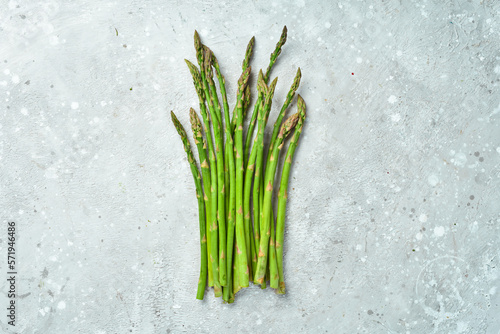 Fresh green asparagus in on a stone background. Healthy food. Top view.