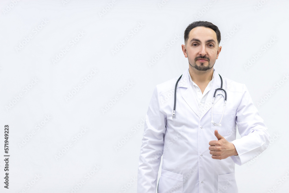 Photo of male mature doctor posing at camera with a stethoscope. Photo of male mature doctor posing at camera with a stethoscope.